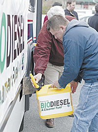 Gerry Baily pours fuel into the BioBus
