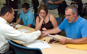 Bob Hopson, left, an admissions officer, speaks with Sarah Welinsky from Tulane University and her father, Gary, during an admissions session for students affected by Hurricane Katrina.