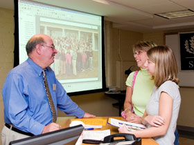 John McNulty, head of academic advising and an instructor in the School of Nursing, talks with high school senior Brittany Robins and her mother, Sue, at the 2005 Open House.
