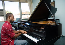 Jason Thomas, a sophomore majoring in piano performance, plays a Steinway in the Music/Drama Building. The music department hopes to raise money to make the University an 'all-Steinway' campus.