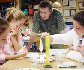 David Moss, University Teaching Fellow and associate professor of curriculum and instruction, works with education majors on a science experiment at Dorothy Goodwin Elementary School in Storrs.