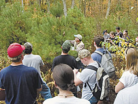 David Schroeder, center, professor and department head of natural resources management and engineering, teaches students how to identify tree species in the UConn Forest.