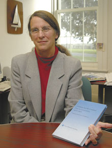 Nancy Steenburg, assistant professor of history at the Avery Point campus, with her book Children and the Criminal Law in Connecticut, 1635-1855.