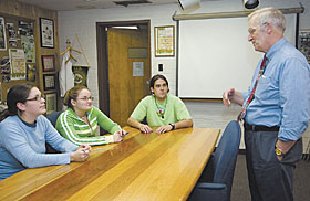 Gene Likens, Distinguished Visiting Research Professor in Ecology and Evolutionary Biology, meets with students, from left, Kathryn Levasseur, Samantha Theodore, and Gabriel Correal during his first annual two-week visit to UConn.