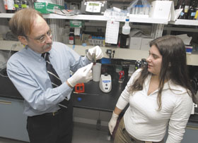 Neuroscientists Steven Pfeiffer, left, and Dr. Cecilia Marta discuss their research at the Health Center. 
