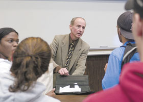 Psychology professor David B. Miller, who has received several awards for teaching, speaks with students after class. 