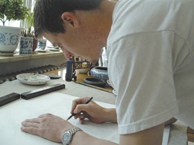 Honors student Matthew Billard begins a work in traditional Chinese style.