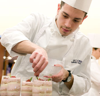 Finishing touch. Chef James Watt of the South Campus dining hall prepares Napoleon Cheesecake Mousse during the sixth annual Culinary Competition, held at Putnam Refectory Jan. 13. Watt's specialty dessert took first prize in the recipe contest. This year's event was covered by the Food Channel.