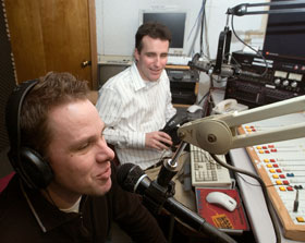 Aaron Sander, foreground, and Ken Cormier, doctoral students in English, co-host The Lumberyard, a new radio magazine for writers and musicians, at the WHUS studio.