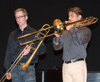 Alex Reicher, left, a student from Yale, gets tips on playing the trombone at a clinic with visiting musician Nitzan Haroz, during an all-day trombone festival at von der Mehden Recital Hall. Haroz has performed as a soloist world-wide, with the Philadelphia Orchestra, the New York Philharmonic, the Jerusalem Symphony, and the Israel Philharmonic Orchestra.