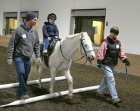 Students taking a new interdisciplinary minor in therapeutic horsemanship will work as interns at therapeutic riding centers, such as this one at High Hopes in East Lyme.