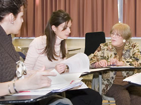 Joan McGuire, right, professor of educational psychology, teaches a graduate class.