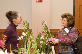 Donna Ryan of Avon, right, and Judy Becker of Salisbury discuss how to grow orchids, during a conference for Garden Enthusiasts March 9.