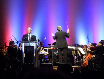 Nafe Katter, left, professor emeritus of dramatic arts, reads Lincoln's Gettysburg address as Keith Lockhart, right, conducts the Boston Pops, at the recent 50th Anniversary Gala of the Jorgensen Center for the Performing Arts.