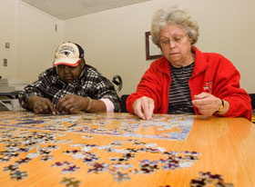 Shirley Plez, right, of Willimantic, and Annie E. Frett, of Windsor assemble a puzzle in a waiting room at the UConn Health Center.
