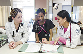 Drs. Maria Soriano, left, and Priya Warrier, right, both residents, discuss a case with Constance Ebron, a nurse, at the UConn Health Center. The week April 17-21 is the Hartford area's first Resident Recognition Week.