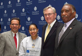 From left, Hartford Mayor Eddie Perez, Crystal Cruz, a scholarship recipient, University President Philip E. Austin, and Ronald Copes, executive director of the MassMutual Foundation after a press conference at Bulkeley High School.