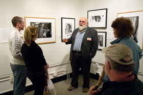 Salvatore Scalora, who is retiring after nine years as director of the Benton Museum, leads a tour of the exhibit Stolen Childhoods: The Global Plague of Child Labor in the museum's Human Rights Gallery.