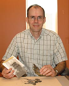 Donald Les, a professor of ecology and evolutionary biology, was part of a research team studying climate change in Peru. Here he shows a specimen of a wetland plant found in the Andes Mountains. The study was published last month in the Proceedings of the National Academy of Sciences. The specimen is now part of UConn's Biology Collections. 