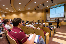 An art history class in a lecture hall in the Biology/Physics Building.
