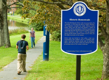 A historic marker near Mirror Lake, one of 11 placed on campus	as	part of the University's 125th anniversary celebration