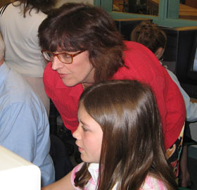 Sally Reis, a professor of educational psychology, looks at a website with a student in a local school.