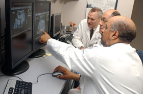 Dr. Winston Campbell, foreground, the Physicians Health Services Endowed Chair in Maternal-Fetal Medicine, reviews ultrasound images with maternal-fetal medicine Fellows, Dr. Yu Ming Victor Fang, center, and Dr. Bruce Morris.