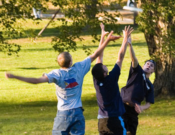 From left, freshmen Scott Hoffman, Dan Galtieri, and Chris Aliapoulios play frisbee beside Mirror Lake.