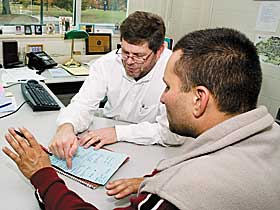 James Hill, left, recipient of the 2006 Outstanding Professional Advisor Award, with a student at the Academic Center for Exploratory Students in the CUE Building.