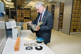 Thomas Wilsted, director of the Thomas J. Dodd Research Center, examines records of the American Montessori Society donated to the archives.
