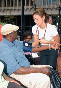 Sara Tabtabai, a student at the UConn School of Medicine, takes a patient's blood pressure at the Old State House during Primary Care Week.