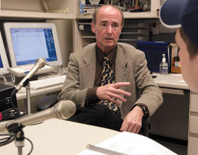 David Miller, professor of psychology, records a podcast at his office with a student.