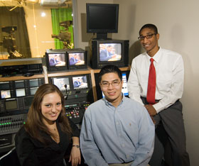 Julie Amenta, left, Pauley Chea, and Brandon Cardwell in the master control room at UCTV. The students have made a documentary about Professor Ronald Mallett's research on time travel.