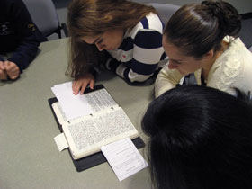 Alexandra Bonneau, left, and Elizabeth O’Neill, students in an interdisciplinary honors course, examine one of Edwin Way Teale’s journals at the Dodd Center.