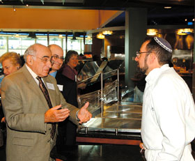 Morris Trachten, left, speaks with chef Bruce Hessing at the kosher dining facility, which was established with a gift from Trachten. He recently donated $1 million to upgrade the University’s Hillel.