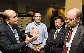 From left, Professor Nejat Olgac and graduate student Ali Ergenc explain a precision device they developed for use in stem cell research to Professor Jerry Yang and Ian Wilmut from the University of Edinburgh, during the StemCONN07 conference last week. Wilmut is known for cloning “Dolly” the sheep.