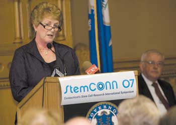 Gov. M. Jodi Rell formally announces the awarding of $20 million in state funds to support stem cell research projects during StemCONN07, a two-day international conference at the state capitol. Seated at right is Dr. Robert Galvin, public health commissioner.