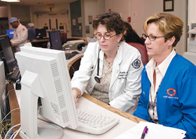 Rosemary Swanks, left, and Dana Vibert use the automated system for entering physicians’ orders at the Health Center.