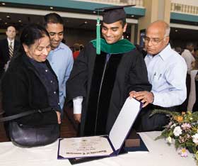 Medical student Mitesh Kabadi shows family members his degree certificate after the Health Center Commencement ceremony May 13. 
