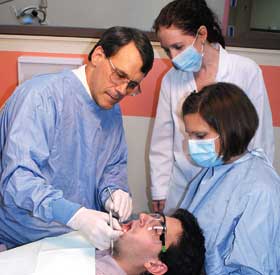 Dr. Frank Nichols in the clinic teaching dental students.