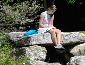 Emily Nirshberg, a senior majoring in English, studies alongside Mirror Lake. 