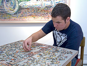 Casey Durand, a junior majoring in marketing, pieces together a puzzle depicting one of Jackson Pollock’s works. The puzzle is part of an exhibition of works inspired by the art and life of Pollock at the Contemporary Art Galleries.