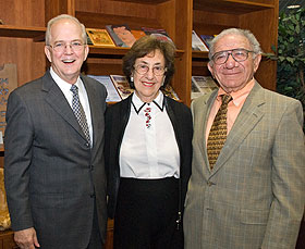 President Michael J. Hogan, left, with Doris and Simon Konover at the Thomas J. Dodd Research Center.