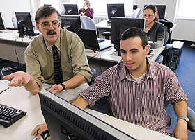 Award-winning educator Daniel Civco, left, a professor of natural resources management, explains a point to Josh Weiss, a senior, in a computer laboratory at the W.B. Young Building.