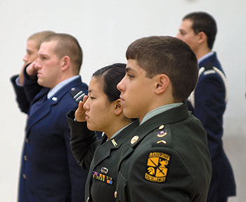 Cadets salute during the playing of Taps at a Veterans' Day celebration in the Student Union Ballroom November 8.