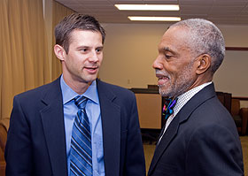 Casey Cobb, associate professor of educational leadership, speaks with John Brittain during a conference on public school choice.