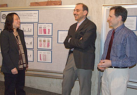 From left, Mei Wei, associate professor of materials science and engineering, speaks with Dr. Joseph Lorenzo, professor of medicine in the Division of Endocrinology and Metabolism, and Dr. Martin Freilich, professor of oral rehabilitation, biomaterials and skeletal development.