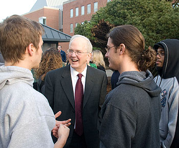 President Michael J. Hogan speaks with, from left, seniors Kevin Pasquaretta and Fred Brewer, and Ryan Brown, a freshman, as they prepare to leave for Biloxi, Miss., on Jan. 8.