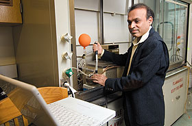 Challa Kumar, professor of chemistry, with research equipment that he and some of his students developed as part of a project to keep greenhouse gases from entering the atmosphere.