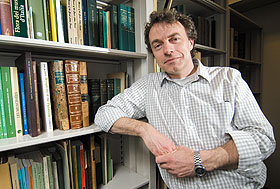 Bernard Goffinet, associate professor of ecology and evolutionary biology, with the recently donated collection of books and manuscripts on the study of mosses.